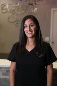 smiling dentist in black uniform